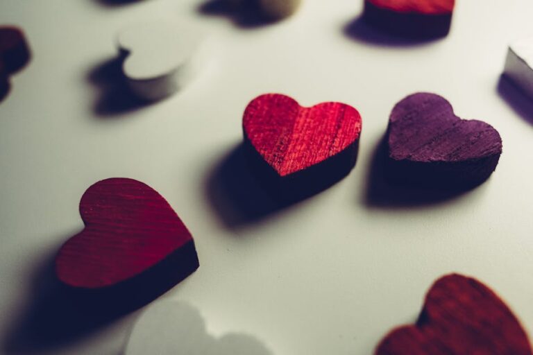Vibrant wooden heart shapes in red and purple, perfect for Valentine's Day decor.