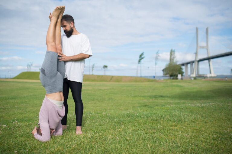 A couple exercises in a grass field near a bridge in Portugal, promoting a healthy lifestyle.