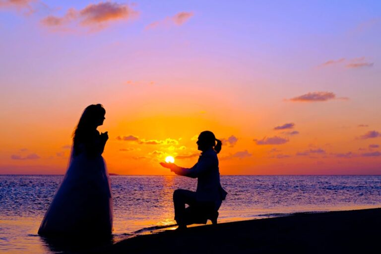 A breathtaking silhouette of a marriage proposal on the beach at sunset, radiating romance.