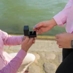 A romantic proposal taking place by a serene riverside, highlighting love and commitment.